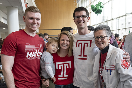 Dr. Amy Goldberg posing with medical students and one's young son on Match Day 2023