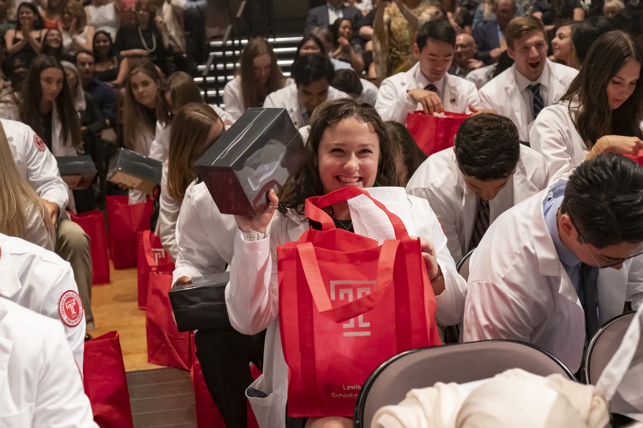 Smiling students unpacking their gifts