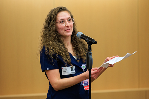 a woman reading aloud at the Story Slam