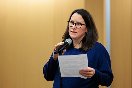 a woman speaking into the microphone at the Story Slam