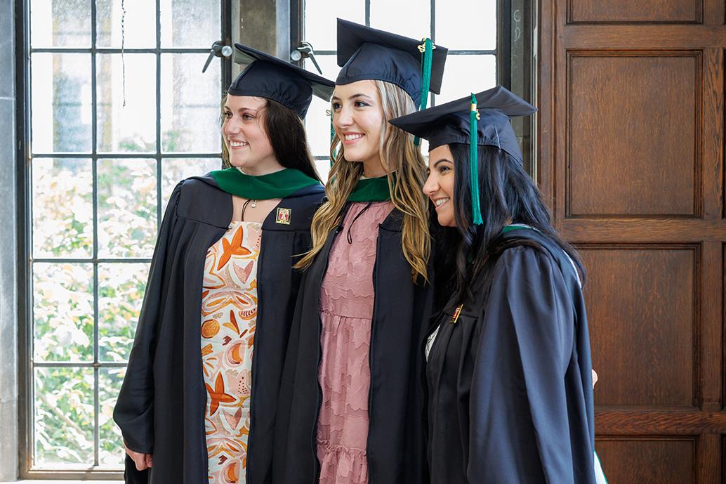 three members of the Pysician Assistant Program in their graduation attire