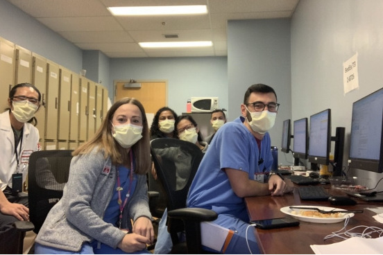 Residents work together while wearing surgical masks
