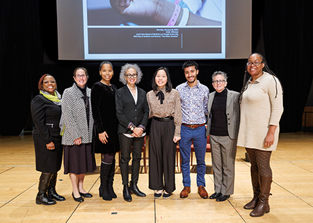 Linda Villarosa and Dr. Amy J. Goldberg posing with a group of four young women and one young man