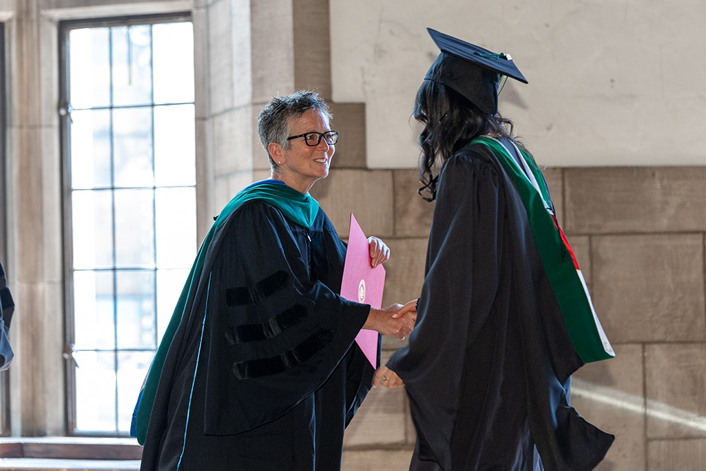 Dr. Goldberg shaking a graduate's hand