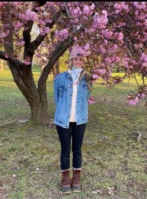Erin Torpey in front of a blooming tree