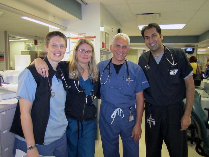 Dave Karras, second from right, associate chair of the emergency medical department, stands in the ED recently with a team of residents, Penny Goode, MD; Karen Siren, MD, and Manish Garg