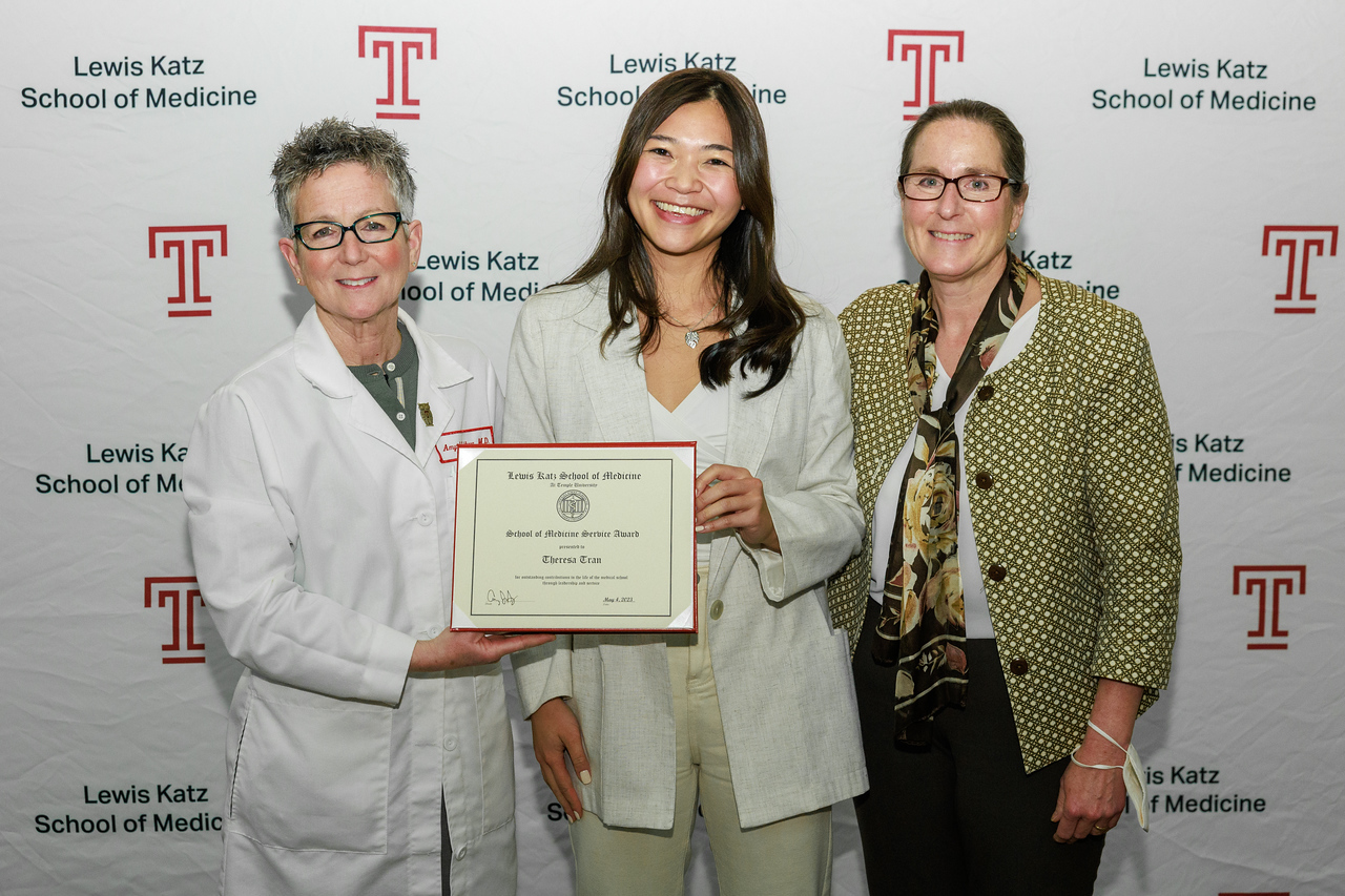 Award recipient Theresa Tran with the Dean and another person