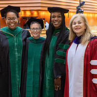  Dr. Amy Goldberg, Dr. Ala Stanford, and two other women wearing graduation gowns