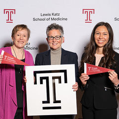 Dr. Amy Goldberg and two women pose with the Temple T and pendants
