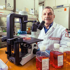 Tomasz Skorski, MD, PhD, DSci, with a microscope in a lab