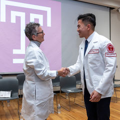 Image of Dean with student at the White Coat Ceremony