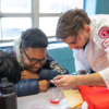 doctor giving kids a demonstration at community clinic