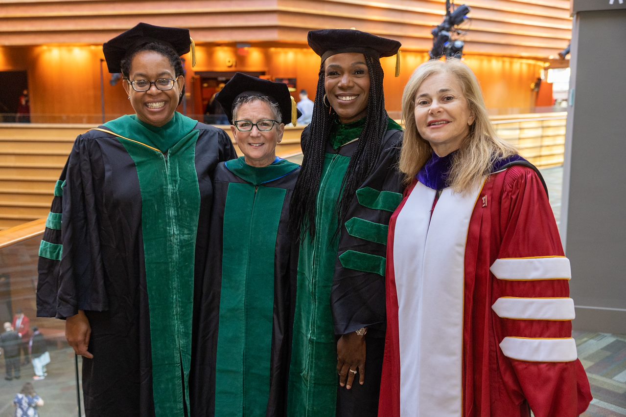 Dr. Amy Goldberg, Dr. Ala Stanford, and two other women wearing graduation gowns